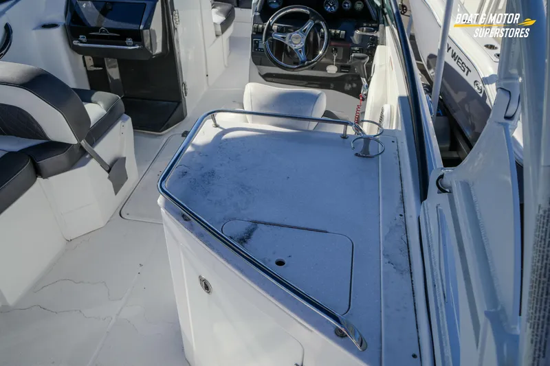 Slide: The Image of Interior of a 2020 Monterey M-65 boat with steering wheel and seating area. - 21