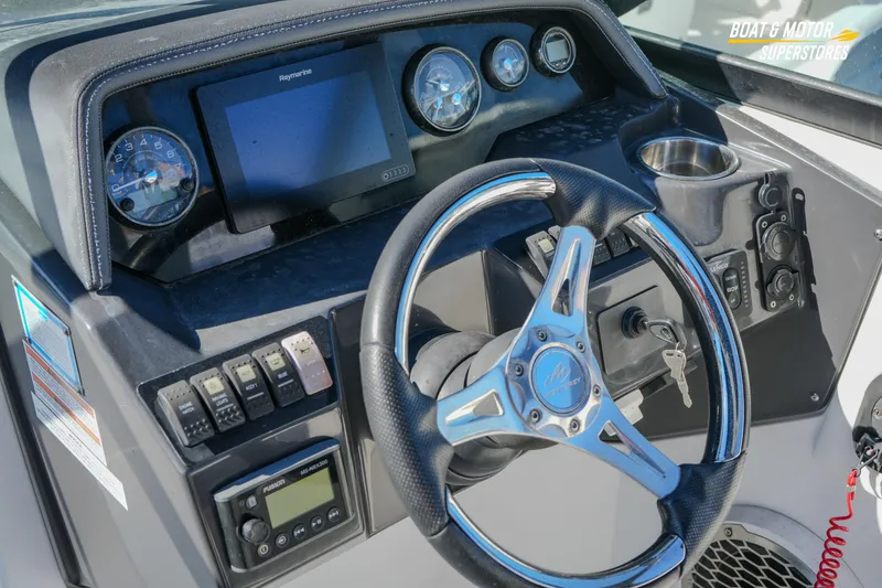 Slide: The Image of 2020 Monterey M-65 boat dashboard with steering wheel and control panel. - 24