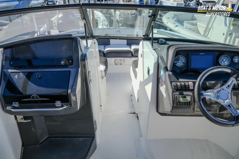 Slide: The Image of 2020 Monterey M-65 boat interior with steering wheel and dashboard controls. - 25