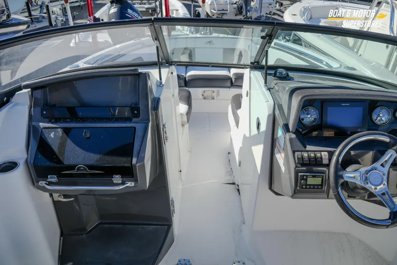 Slide: The Image of 2020 Monterey M-65 boat interior with steering wheel and dashboard controls. - 26
