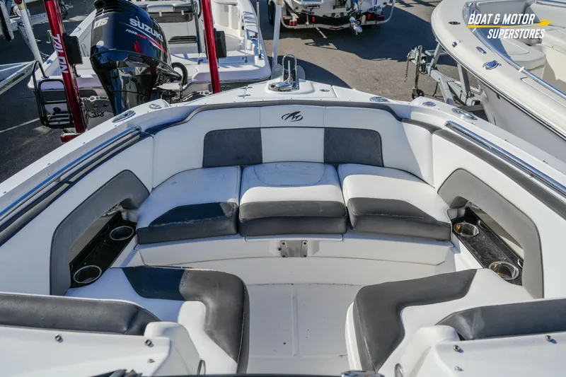 Slide: The Image of 2020 Monterey M-65 boat interior with cushioned seating and cup holders. - 28