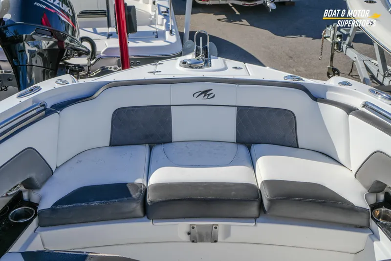 Slide: The Image of 2020 Monterey M-65 boat interior with cushioned seating and sleek design. - 29
