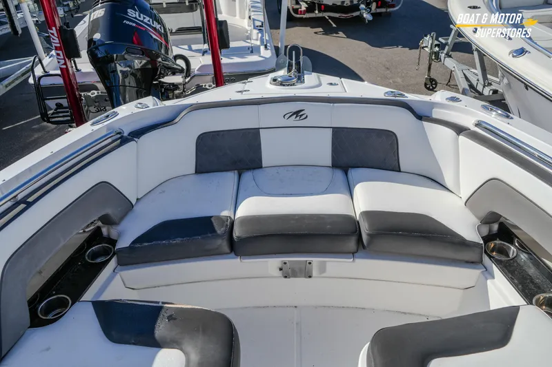 Slide: The Image of 2020 Monterey M-65 boat interior with cushioned seating and cup holders. - 30