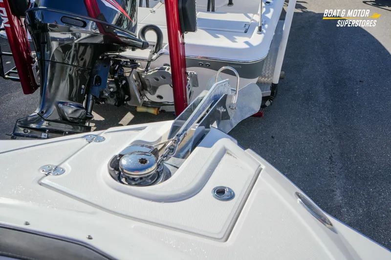Slide: The Image of 2020 Monterey M-65 boat with anchor and outboard motor at dealership. - 32