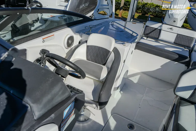 Slide: The Image of 2020 Monterey M-65 boat interior with steering wheel and seating area. - 36
