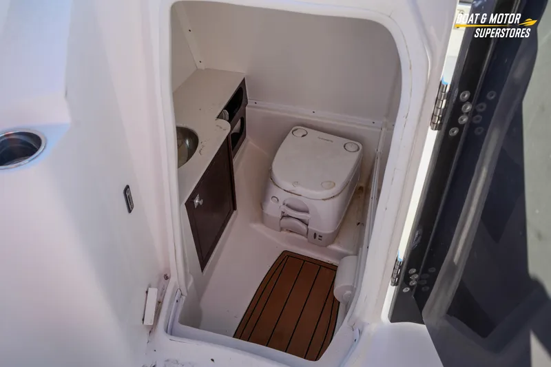 Slide: The Image of 2020 Monterey M-65 boat interior with compact toilet and sink area. - 38