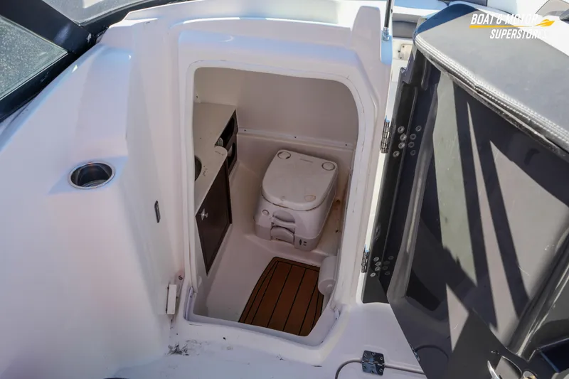 Slide: The Image of 2020 Monterey M-65 boat interior with compact marine toilet and storage. - 39