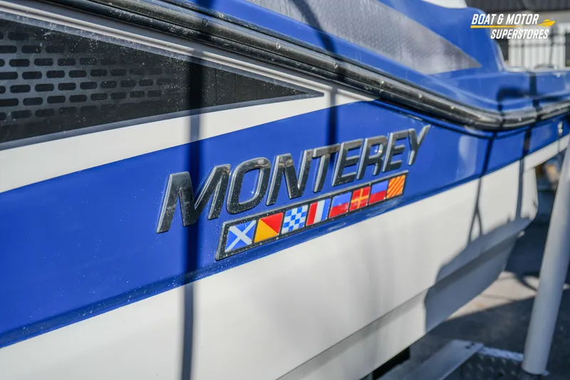Slide: The Image of 2020 Monterey M-65 boat with nautical flags and branding. - 4