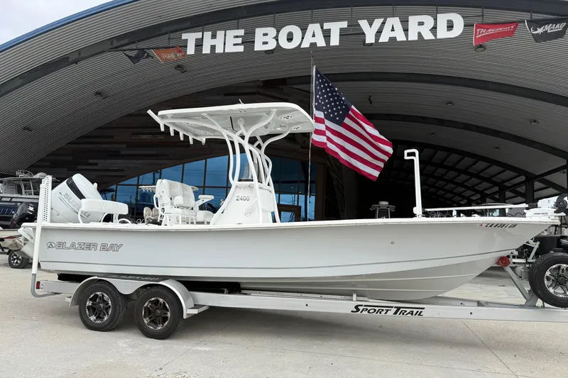 The Image of 2021 Blazer Bay 2400 boat on trailer at The Boat Yard, American flag displayed. - 1