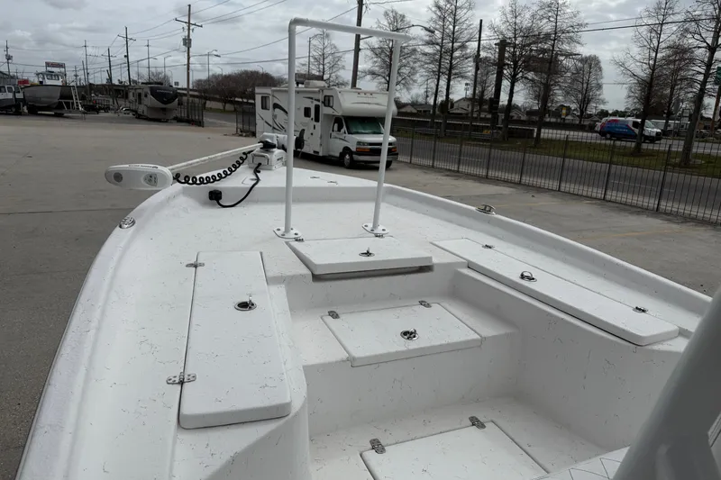 Slide: The Image of 2021 Blazer Bay 2400 boat deck with storage compartments and trolling motor. - 8