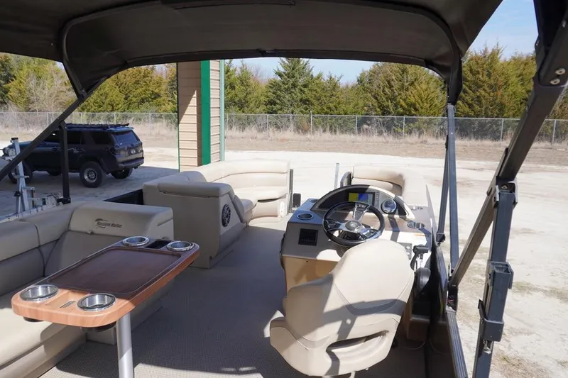 Slide: The Image of 2021 Massimo Marine P23 MAX LIMITED pontoon boat interior with seating and steering console. - 13