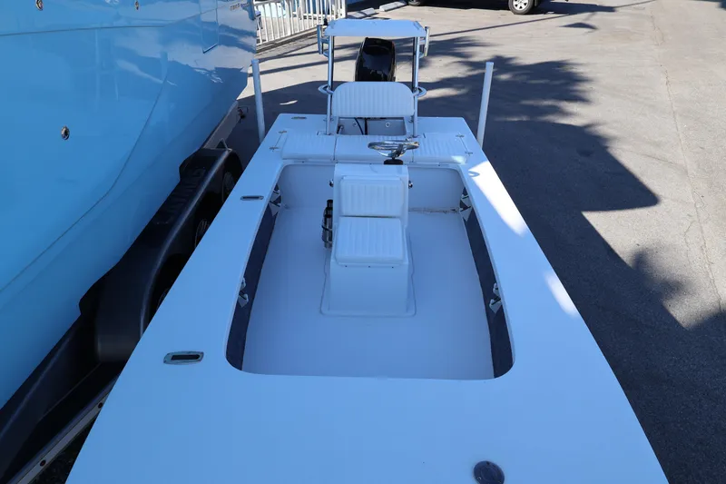 Slide: The Image of 2026 Mitzi Skiffs 17 Tournament boat, white deck, parked outdoors. - 11