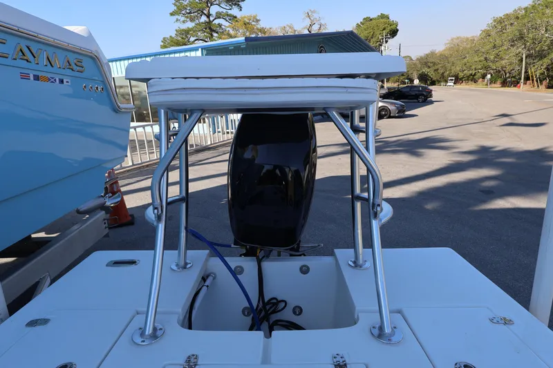 Slide: The Image of 2026 Mitzi Skiffs 17 Tournament boat with motor and seating, parked outdoors. - 16