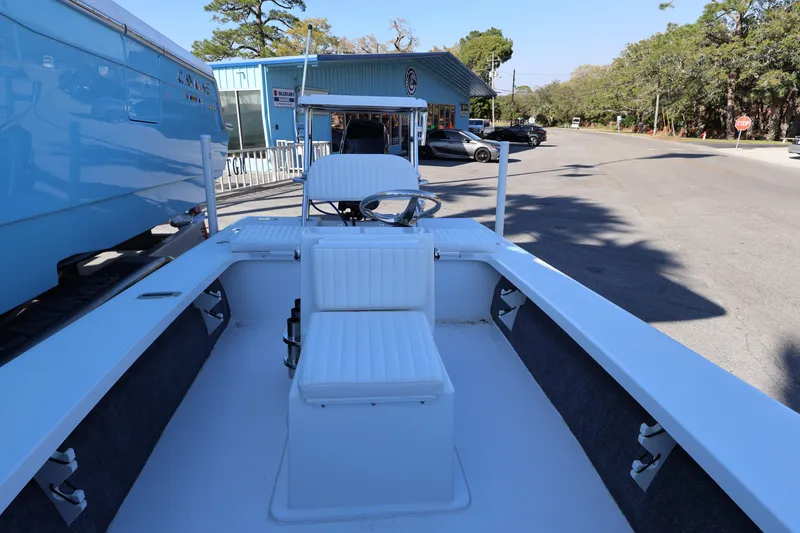 Slide: The Image of 2026 Mitzi Skiffs 17 Tournament boat parked on a street, showcasing interior seating. - 18