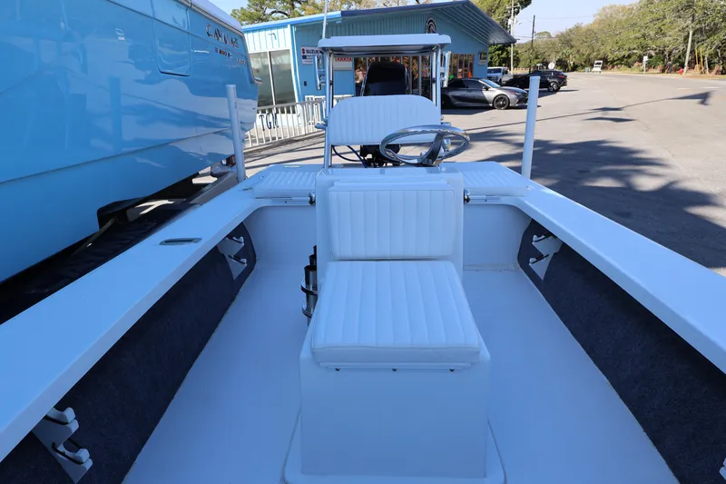 Slide: The Image of 2026 Mitzi Skiffs 17 Tournament boat interior with white seating and steering wheel. - 19