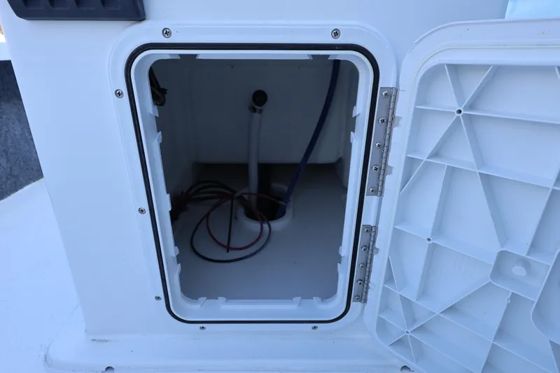 Slide: The Image of Open storage compartment on 2026 Mitzi Skiffs 17 Tournament boat, showing interior wiring. - 25