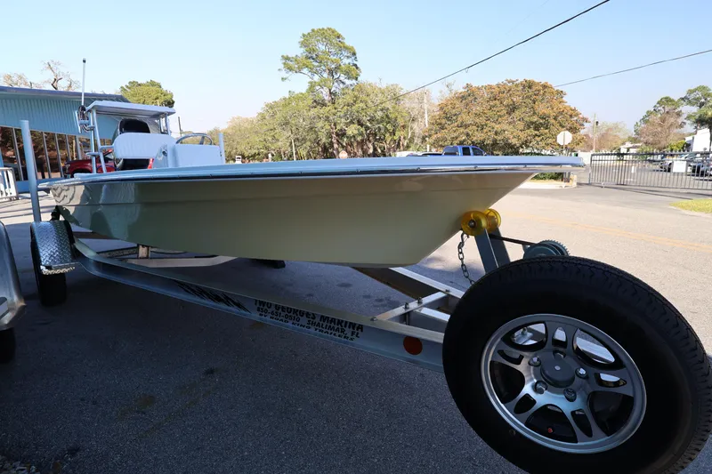 Slide: The Image of 2026 Mitzi Skiffs 17 Tournament boat on trailer, parked outdoors. - 6