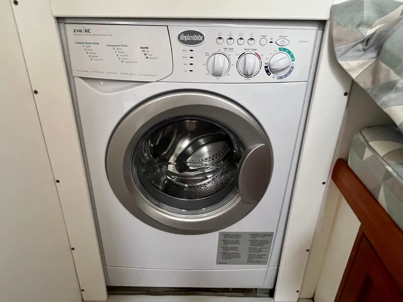 Slide: The Image of Splendide washing machine in a Wesmac 42, 2016 model, compact laundry area. - 48