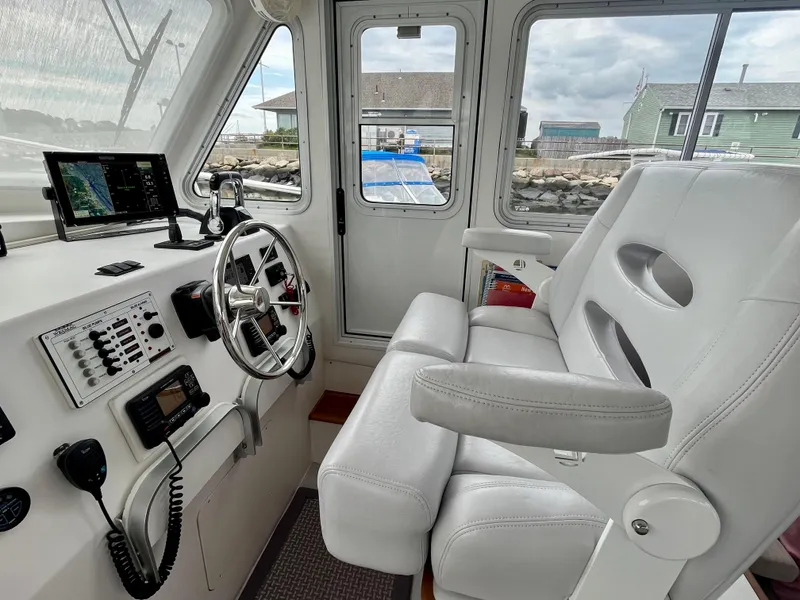 Slide: The Image of Interior of 2016 Wesmac 42 boat with steering wheel and navigation equipment. - 40