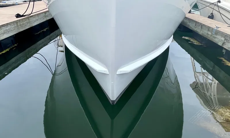 Slide: The Image of Wesmac 42 boat from 2016 docked, reflecting on calm water. - 9