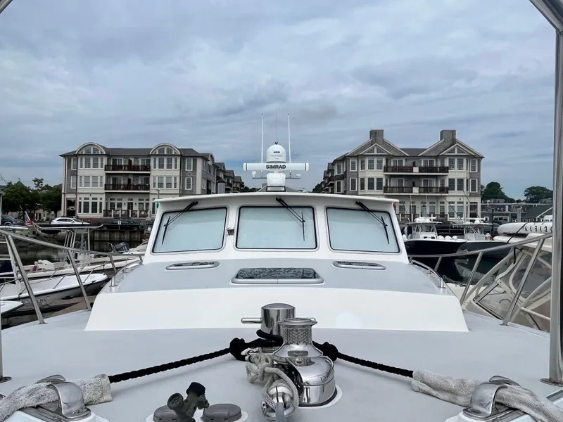 Slide: The Image of Wesmac 42 boat docked at marina with waterfront buildings, 2016 model. - 7