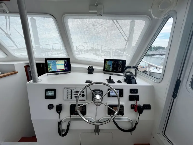 Slide: The Image of Wesmac 42 boat helm, 2016 model, featuring navigation screens and steering wheel. - 32