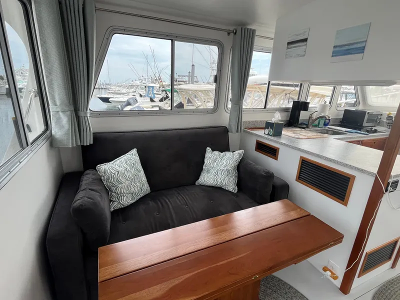 Slide: The Image of Cozy interior of 2016 Wesmac 42 boat with sofa and wooden table. - 23