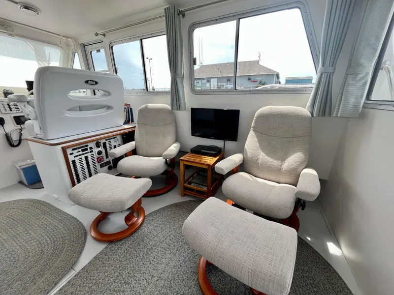 Slide: The Image of Interior of 2016 Wesmac 42 boat with comfortable seating and control panel. - 29