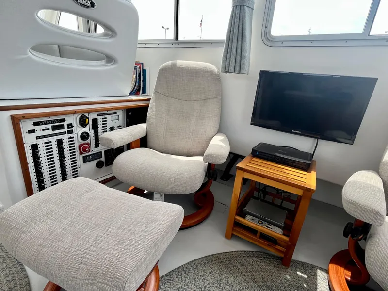 Slide: The Image of Cozy interior of 2016 Wesmac 42 boat with seating, control panel, and TV. - 30