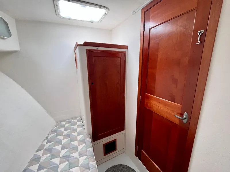 Slide: The Image of Cozy cabin interior of 2016 Wesmac 42 with wooden door and storage. - 49