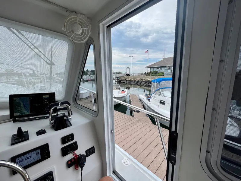 Slide: The Image of View from inside a 2016 Wesmac 42 boat, overlooking a marina dock. - 41
