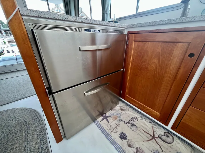 Slide: The Image of Stainless steel drawers in 2016 Wesmac 42 boat interior, next to wooden cabinetry. - 26