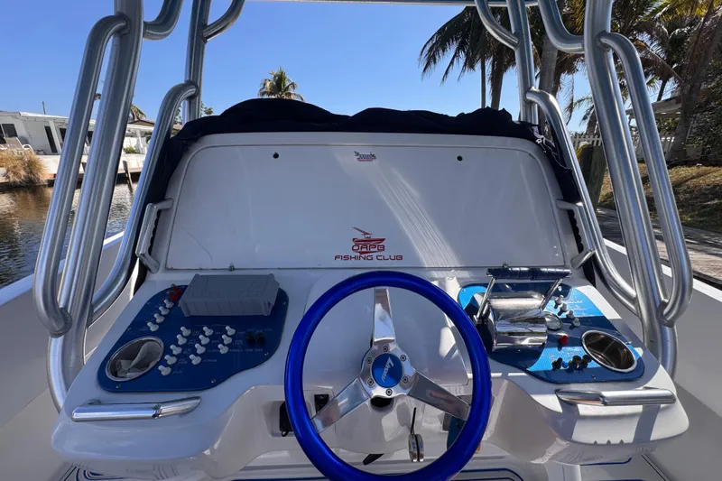 Slide: The Image of 2004 Don Smith 45 Custom boat dashboard with blue steering wheel and control panels. - 10