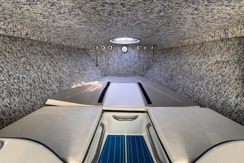 Slide: The Image of Interior cabin of a 2004 Don Smith 45 Custom boat, featuring cushioned seating and a hatch. - 11