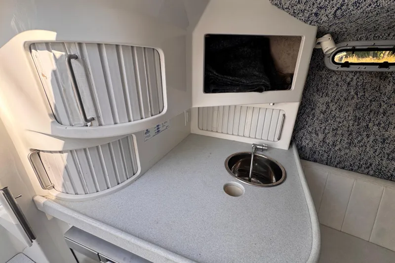 Slide: The Image of Compact kitchenette in 2004 Don Smith 45 Custom boat with sink and storage cabinets. - 13