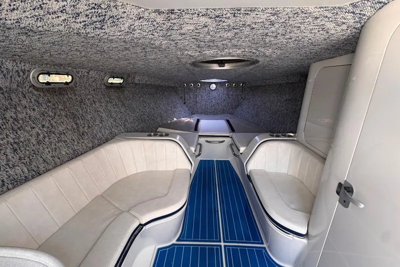 Slide: The Image of Interior of a 2004 Don Smith 45 Custom boat with blue flooring and white seating. - 14