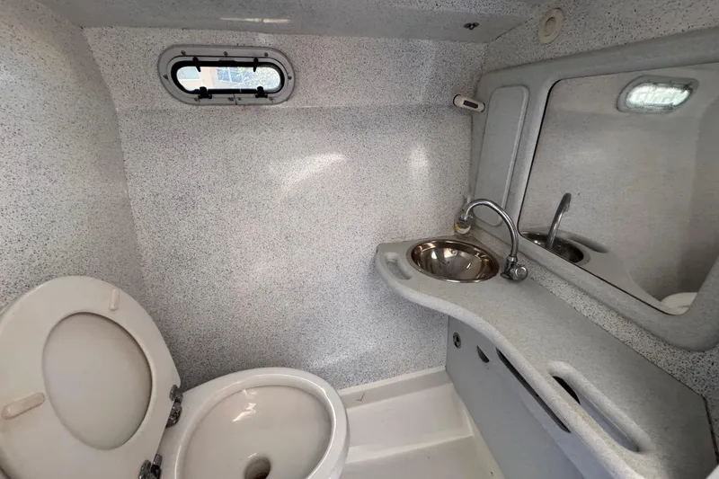 Slide: The Image of Compact bathroom in a 2004 Don Smith 45 Custom boat, featuring a toilet and sink. - 16