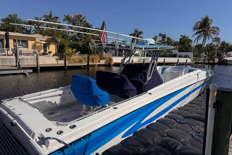 Slide: The Image of 2004 Don Smith 45 Custom boat docked by a canal, surrounded by palm trees. - 6