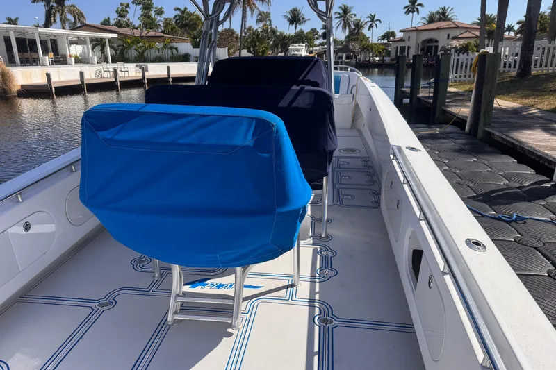 Slide: The Image of Boat interior of 2004 Don Smith 45 Custom with blue seat covers, docked by a canal. - 7
