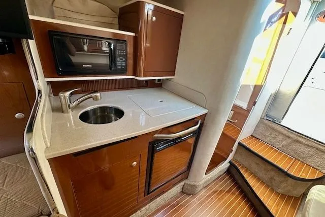 Slide: The Image of 2009 Sea Ray Sundancer 280 with black canopy at the dock. - 21