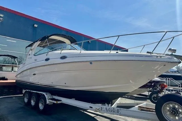 Slide: The Image of Interior seating of 2009 Sea Ray Sundancer 280 boat, featuring white and beige upholstery. - 8