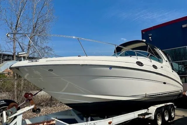 Slide: The Image of 2009 Sea Ray Sundancer 280 cockpit with white leather seating and control panel. - 9