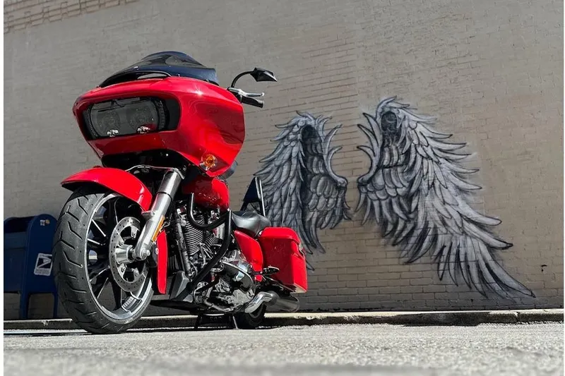 Slide: The Image of Red 2023 Ranger Z520R Cup-Equipped motorcycle parked near angel wing mural on brick wall. - 7