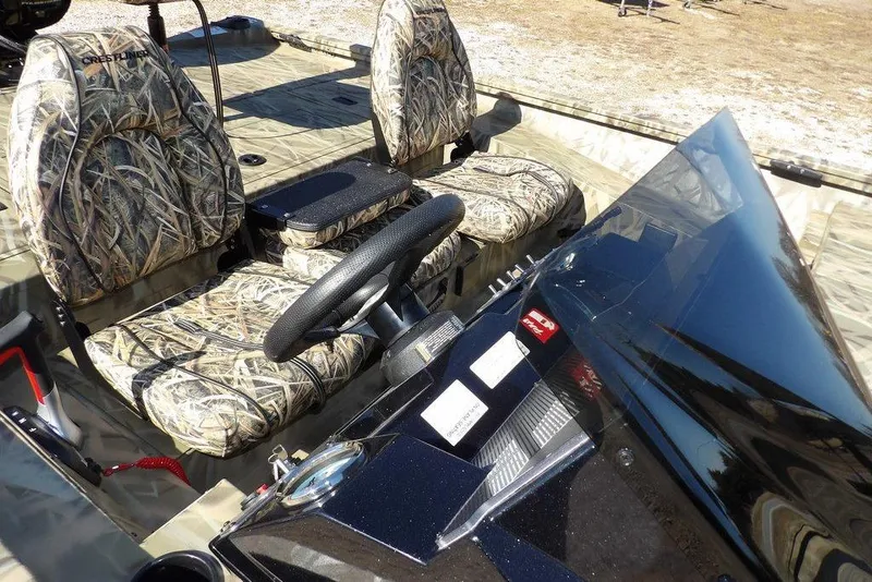 Slide: The Image of 2026 Crestliner XFC 189 boat interior with camo seats and steering console. - 11