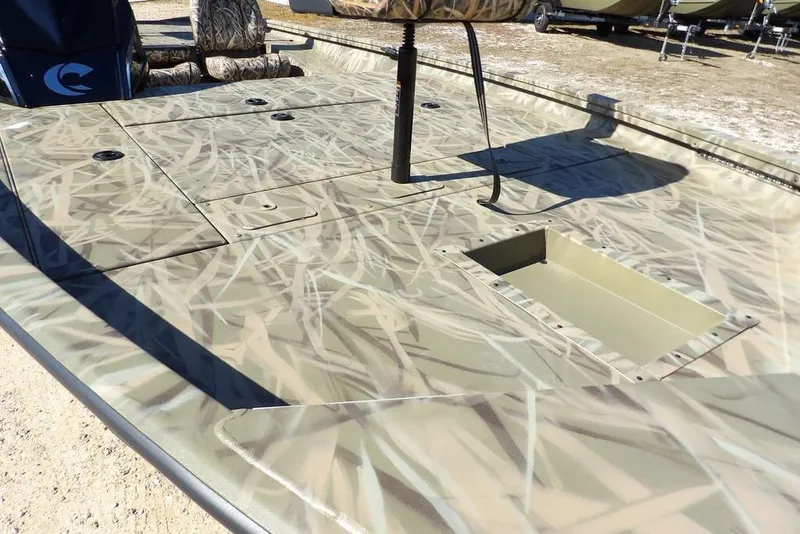 Slide: The Image of 2026 Crestliner XFC 189 boat with camouflage deck design, featuring storage compartments. - 13
