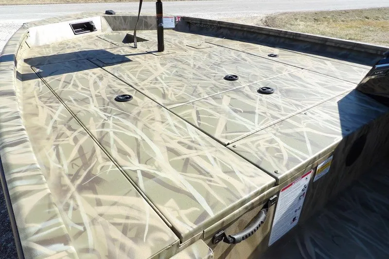 Slide: The Image of 2026 Crestliner XFC 189 boat deck with camouflage pattern, featuring storage compartments. - 14