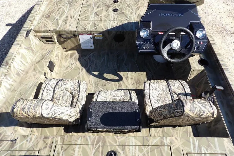 Slide: The Image of 2026 Crestliner XFC 189 boat interior with camouflage seats and steering console. - 17