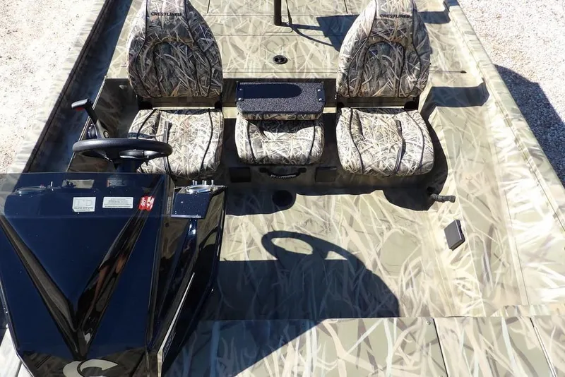 Slide: The Image of 2026 Crestliner XFC 189 boat interior with camouflage seats and steering console. - 20