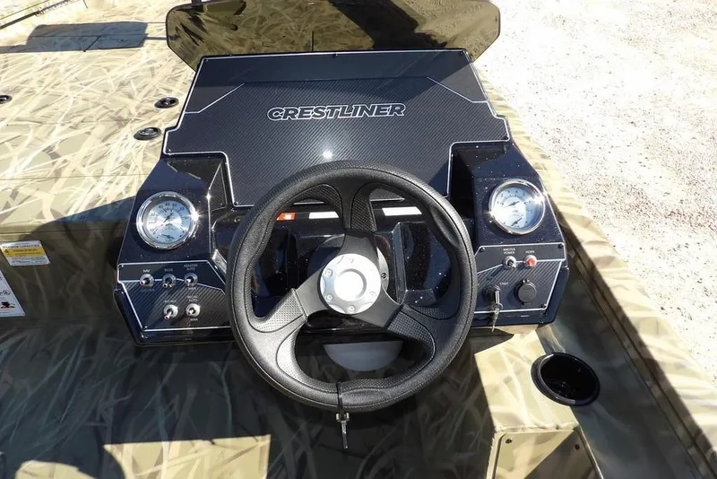 Slide: The Image of 2026 Crestliner XFC 189 boat dashboard with steering wheel and gauges. - 21