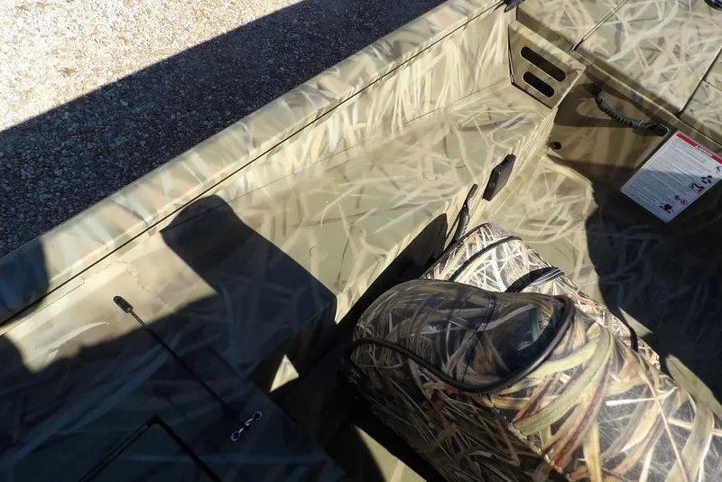 Slide: The Image of 2026 Crestliner XFC 189 boat interior with camouflage design and seating. - 22